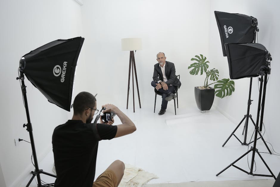 Photographer capturing a model in a sleek studio environment with professional lighting.